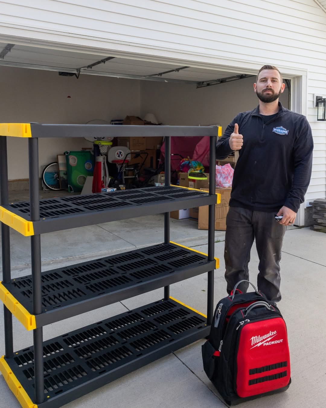 Blue Lake Handyman technician next to assembled garage shelving unit